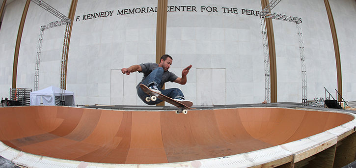 Ben Ashworth, Sculpture Studio Supervisor and former MFA student at Mason's School of Art, rolls through a skate bowl that he and his team built. It was placed in front of the Kennedy Center for the festival Performing Arts for Finding A Line: Skateboarding, Music, and Media. Photo by John Falls