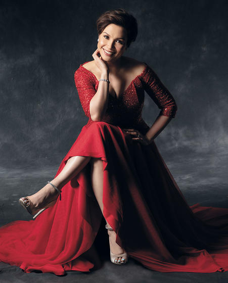 Lea Salonga dressed in red dress and seated